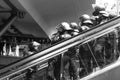 German police special forces in a stand by on an escalator in black and white